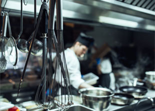 Line cook with kitchen tools