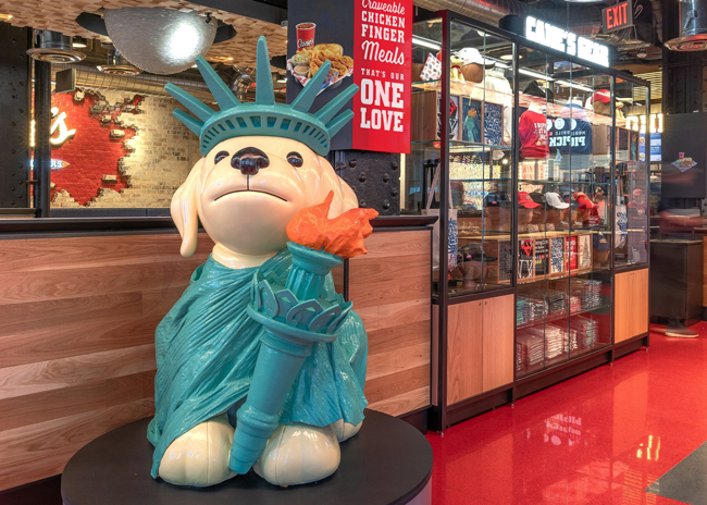 Raising Cane's opened a flagship location in New York City’s Times Square. The 8,000-square-foot restaurant features a custom mural painted live by New York-based artist Timothy Goodman, custom design elements for the New York City Market and many nods to its namesake and mascot, the beloved yellow lab Cane.