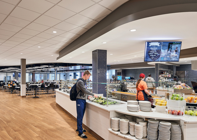 A salad bar greets customers entering the dining hall.