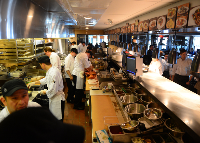 At Hudson 29, an expediter checks the kitchen display system to ensure orders are accurate and served as quickly as possible. 