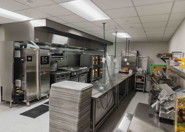 The back of the house contains a smoker, a 4-burner range, a salamander, a flattop griddle, a charbroiler and convection ovens.