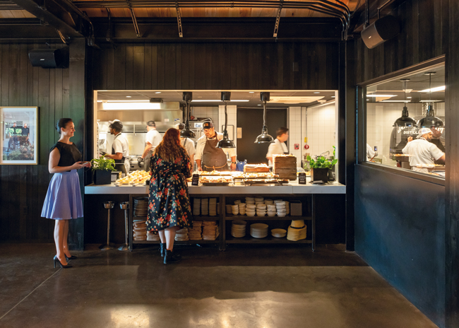 Guests interact with culinary team members as they prepare the menu.