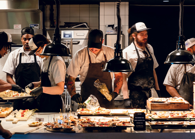 Culinary team members assemble appetizers for an event at The Kitchen Table.