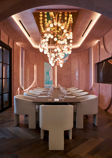 The chef’s table private dining room is enveloped in a graceful arrangement of pink plastered panels and features a chandelier that evokes different moods depending on the cuisine being served.
