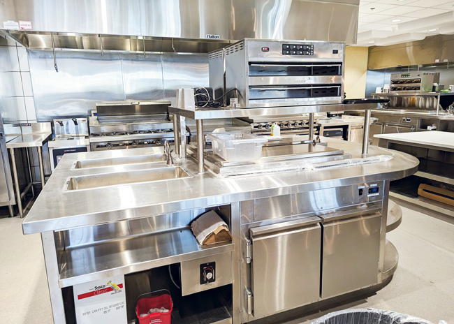 Soul contains fryers, a range with a cold rail above, a griddle, charbroiler and hot holding cabinets. 