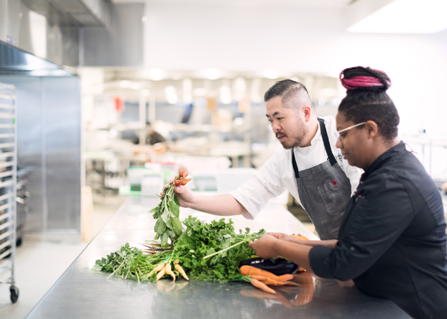 Corporate foodservice providers increasingly emphasize prepared-to-order fresh and often locally sourced vegetables and fruits, requiring kitchen space and labor for more chopping, cutting and prep.  Photo courtesy of Guckenheimer