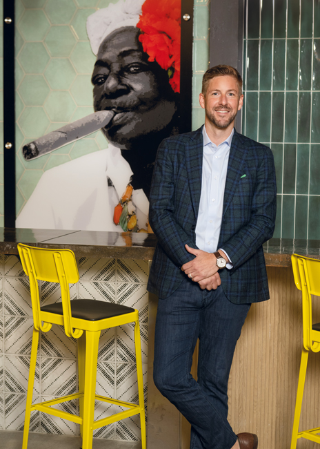 The mural behind Nick Taylor  introduces customers to Hemingway’s Cuban Kitchen. The Kern’s Food Hall site adds a third location for the  concept, which originated in Tampa, Fla.