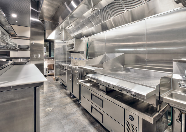 This grill station design follows the rule that a straight-line design simplifies cooking across different equipment types.  Photo by Skibbee Photography