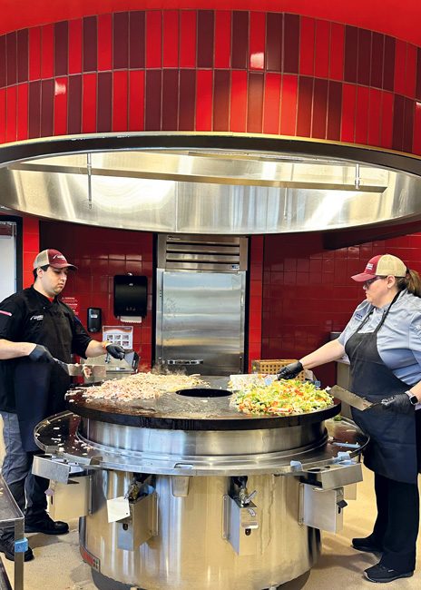 Dishes are prepared at a saute station with a Mongolian grill.