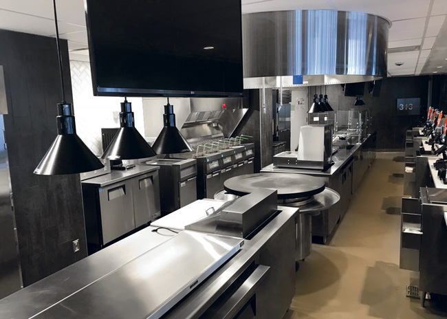 In the kitchen at Little Caesars Arena in Detroit, the dual cookline is parallel, with a separate fry station.  Photo courtesy of YoungCaruso