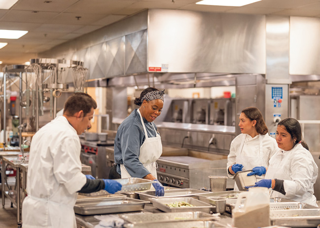 Sodexo Live! team members prepare menu items for a banquet. Photo by Nikki A. Rae