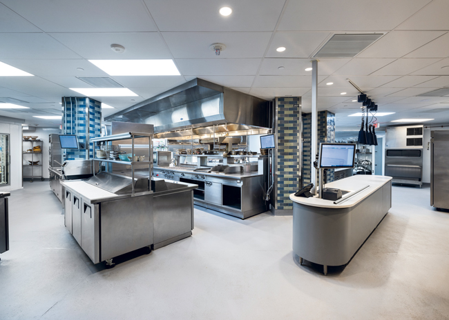 The columns covered in colorful tiles in the kitchen add a design element.