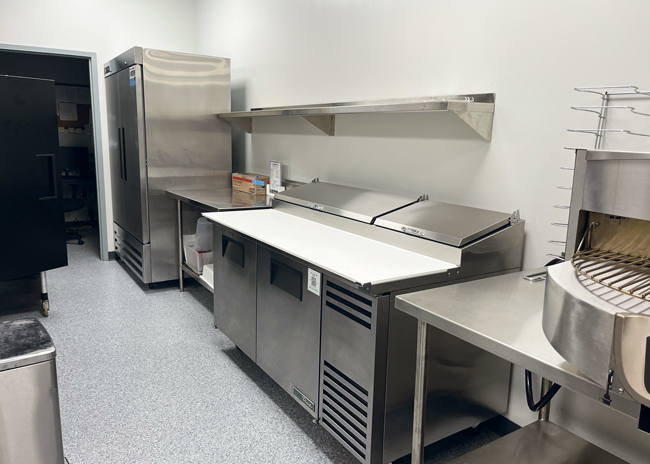 A circular deck oven, refrigerated rail and refrigerator support meal production.