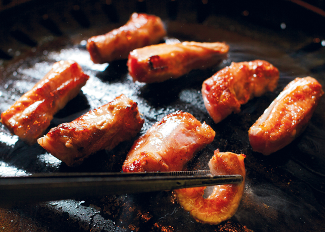 At Chicago’s Perilla Fare and sister spot Perilla  Steakhouse tableside grilling is part of the experience that combines traditional Korean ingredients and more modern dishes to  create a cuisine that embraces the owners’ Korean American background. Photo courtesy of Perilla Fare; Photo by Jeremy Yap