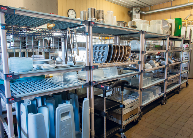 Wet items are stored where they dry. The linear approach to the upgraded storage creates a distinct division in the large space between the dish pit area and the prep space on the other side.