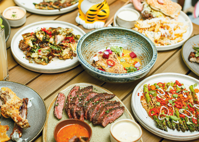 Perilla Fare’s menu ranges from scallion pancakes and kimchi fried rice to gochujang pork ribs and chicken tender sandwiches with fries. Photo courtesy of Perilla Fare; Photo by Jeremy Yap