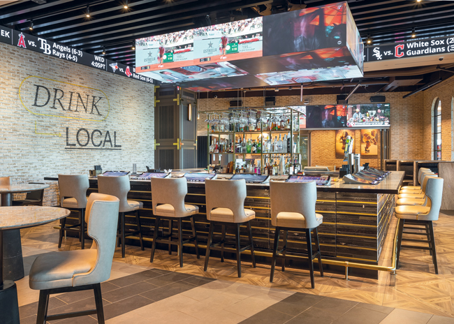 Guests sitting at the bar at (209) Sports Bar + Kitchen can gamble while watching sports events.