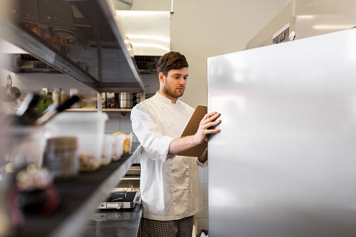 Parts Town -Staff Checking Reach-In Fridge