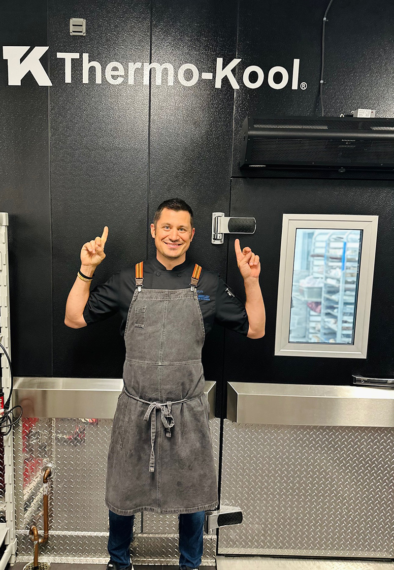Chef Kyle Wilson of Middleby Innovation Kitchens in front of his walk-in from Thermo-Kool.